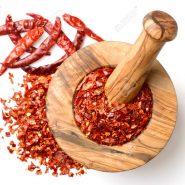 dried red chilli flakes in the wooden mortar, isolated on white background